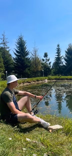 Team member fishing by a lake