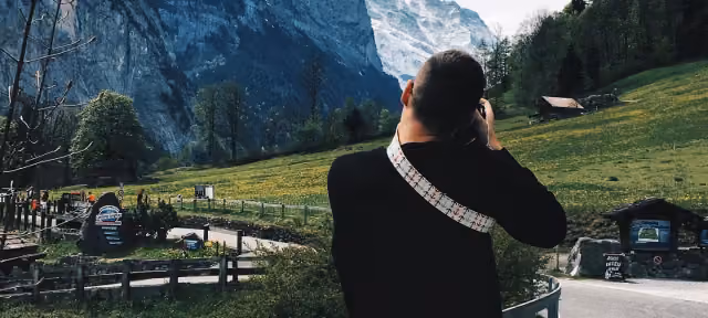 Team member photographing a mountain valley