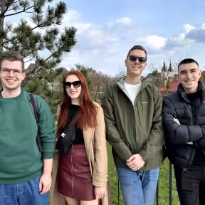 Four team members on a walk in a park