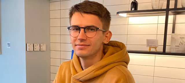 Portrait of a Flexum team member in a hoodie