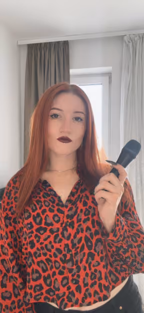 Portrait of a Flexum team member holding a microphone