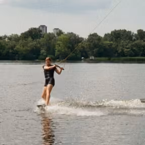 Team member wakeboarding on a river